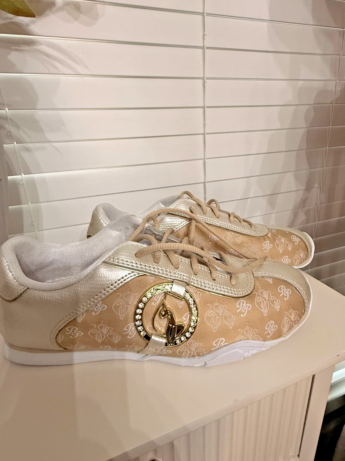 Vintage Y2K Baby Phat sneakers in white with gold accents. s