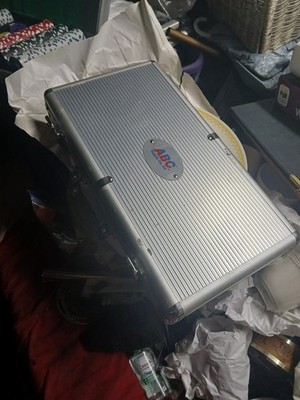 silver aluminum carrying case, likely used for a poker chip set. With Some Chips