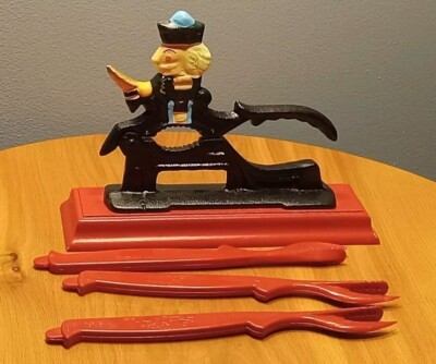 Holiday Multi-colored Cast Iron Nutcracker Red Wood Base with Plastic Picks