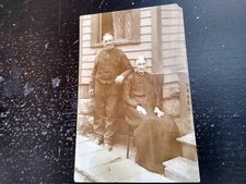 Older Couple Leaning On Side Of House RPPC Real Photo Postcard