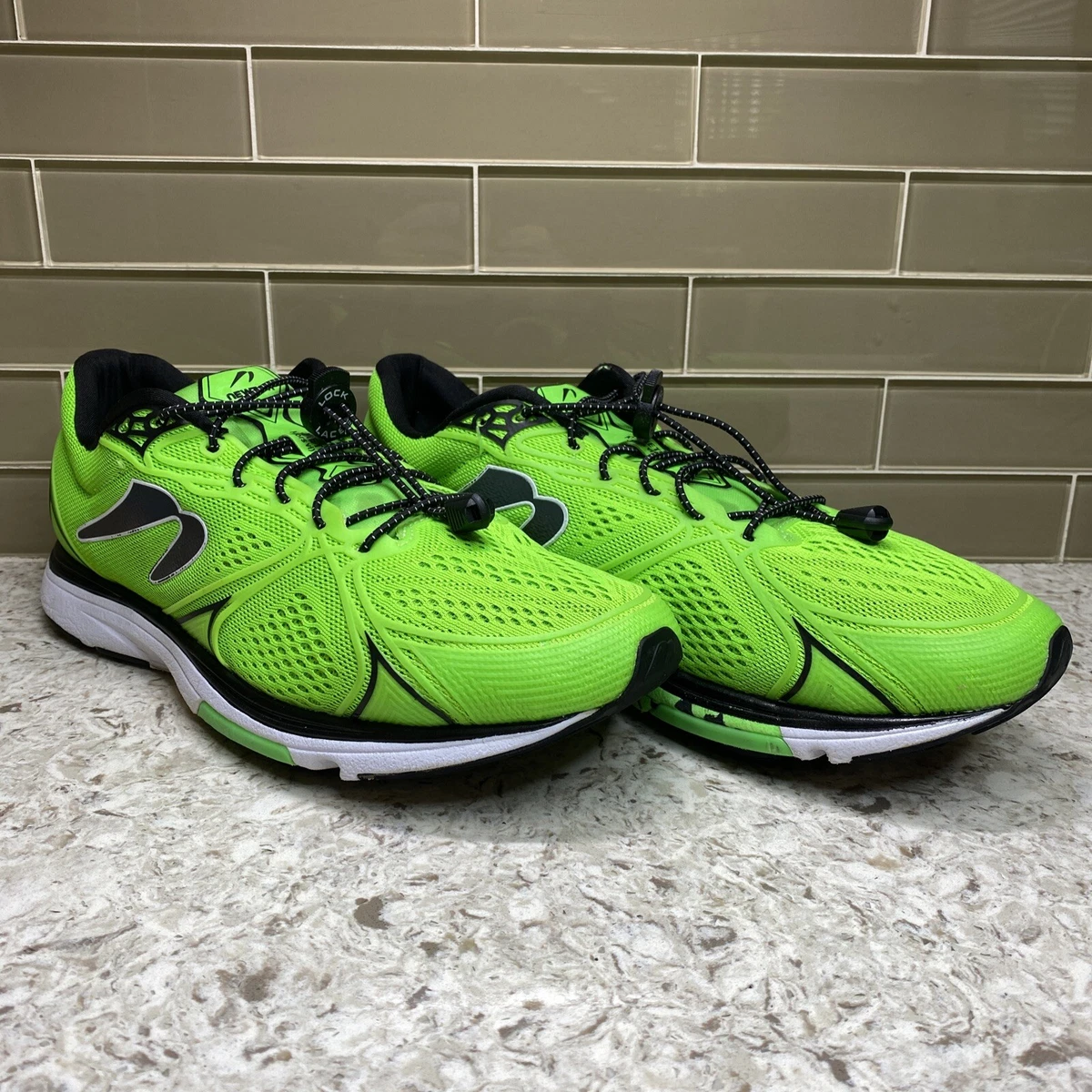 Green and black running best sale shoes