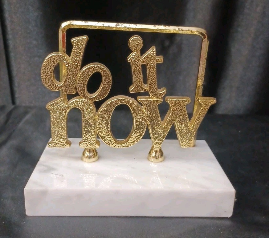 A marble-based gold metal letter rack stamped 'DO IT NOW' — motivational MCM desk decor with an attitude that still slaps.