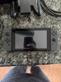 Nintendo Switch Console with Dock, Controller Grip, Power Adapter, and Cables
