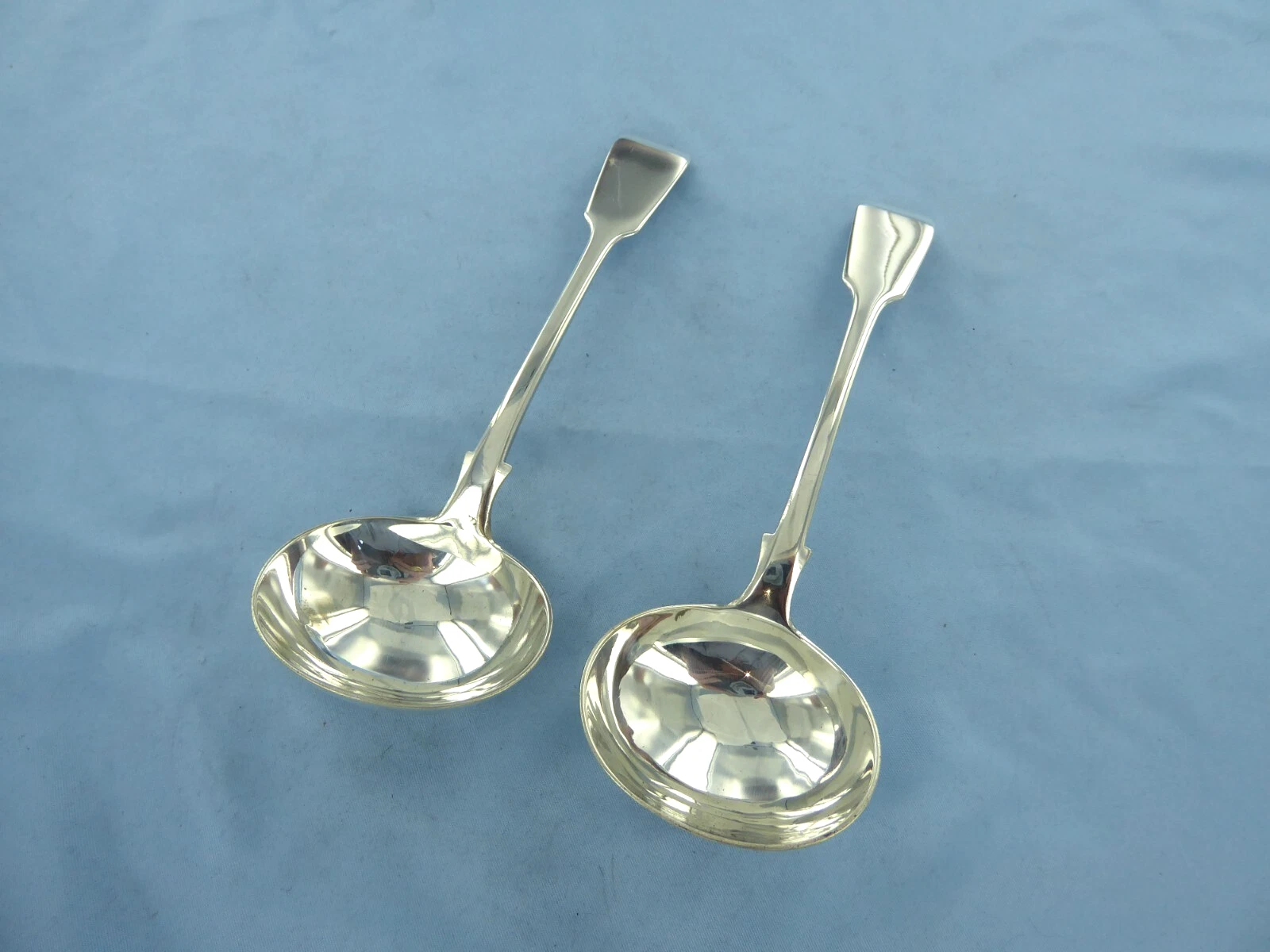AN ANTIQUE PAIR OF STERLING SILVER, FIDDLE BACK SAUCE LADLES, LONDON 1881.
Opens in a new window or