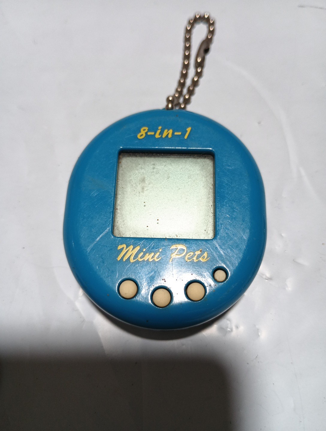 two giga pets keychain games and one 8-in- 1 mini pets 