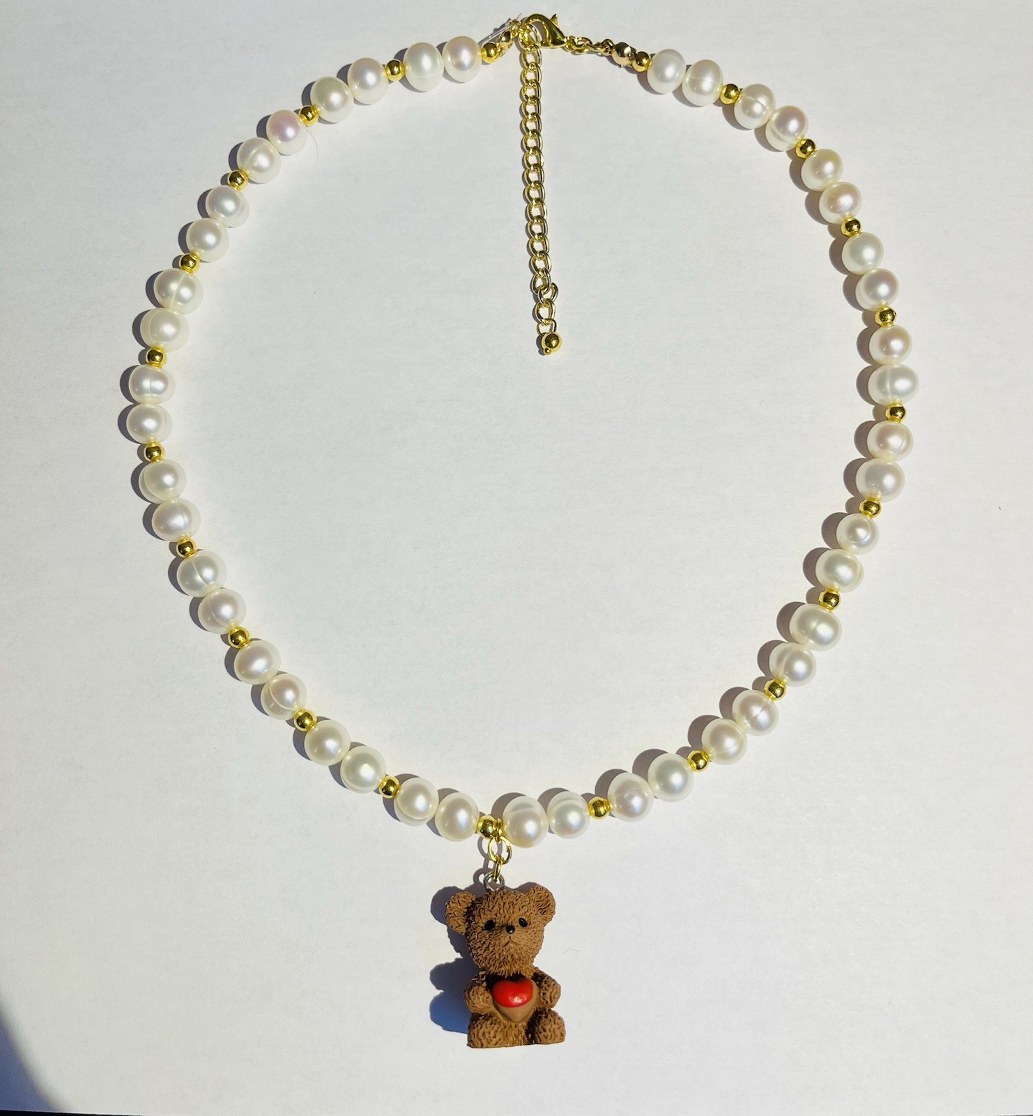Teddy bear charm pendant necklace with pearls.