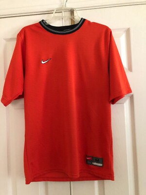 orange white and black nike shirt