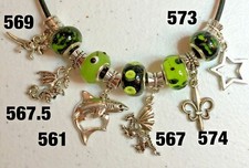 PICK A CHARM: SHARK, DRAGON, REVOLVER, LEOPARD, ROOSTER, PUZZLE, ANNIVERSARY