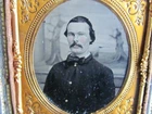 Civil War soldier posed in front of a backdrop tintype photograph
