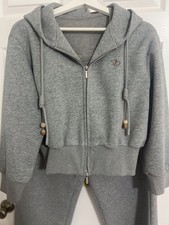 grey women's matching tracksuit set featuring a zip-up hoodie, a sleeveless top