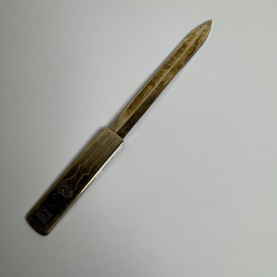 A genuine vintage Tiffany & Co. silverplated letter opener with engraved logo — understated luxury flex for the executive desk.