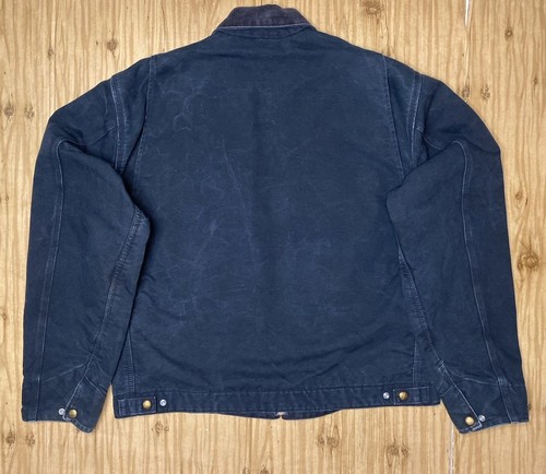 Black VTG Carhartt J01 BLK Detroit jacket with back zipper, button front, and two front flap chest pockets made in USA.