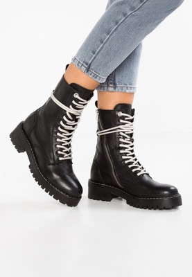 white and black combat boots