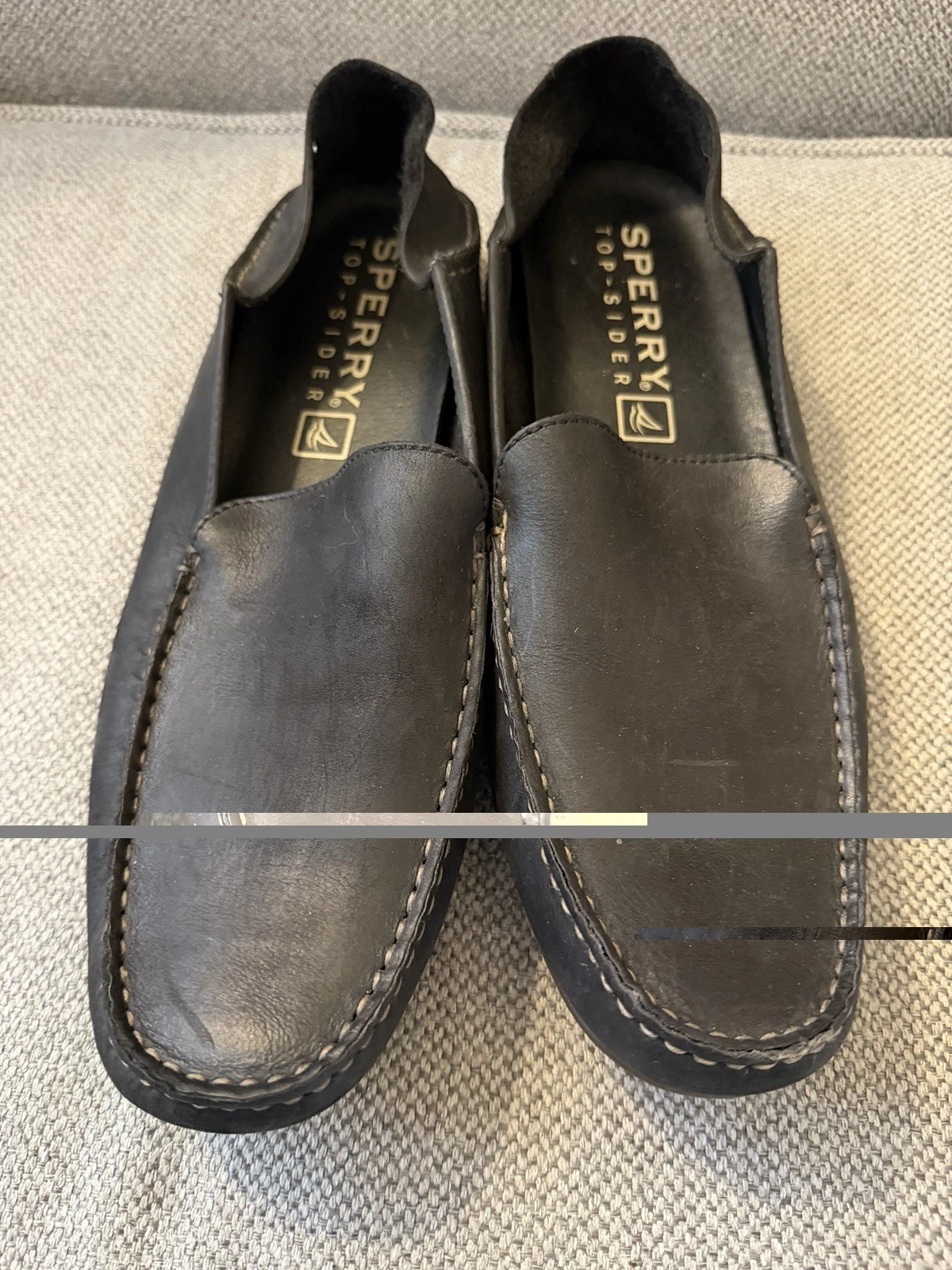 black leather Sperry Top-Sider driving loafers feature a slip-on design