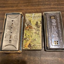 two M Hohner Echo harmonicas with rough boxes dofferent styles