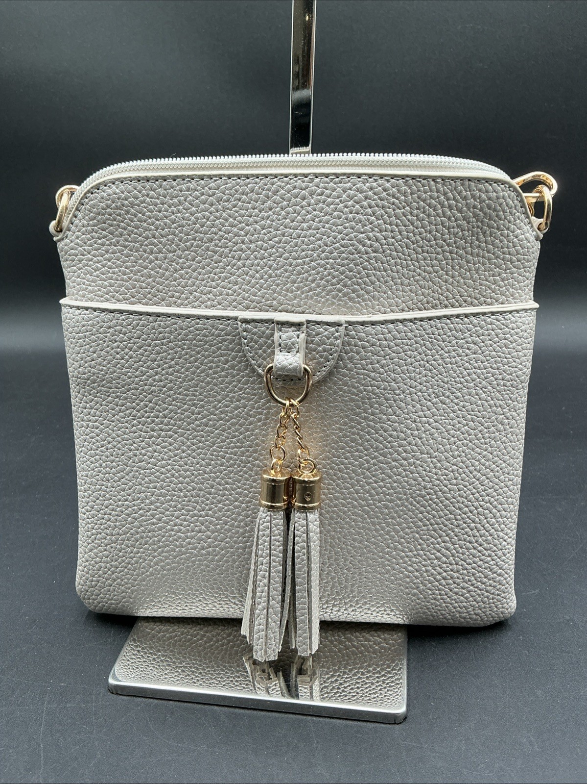 Elegant  Pebbled Leather Crossbody Bag with Stylish Gold Tassel Accent