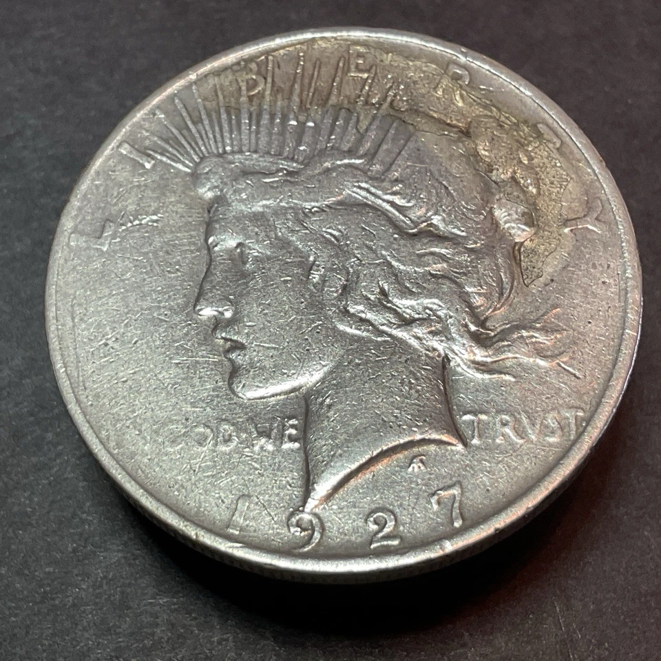 Dólar de plata Peace 1927-D - Error de freno de troquel anverso Foto 4 de 4