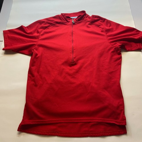 Red mesh Izumi men’s cycling shirt with half zip, made in USA, shown flat with light gray background.