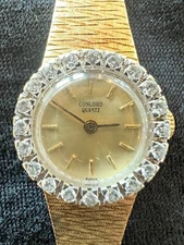 Concord ladies 14k yellow gold bracelet watch with diamond bezel.Quartz movement
