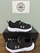 Under Armour Girls' Infant Assert 10 AC, 001 Black/Black/Metallic Gold, 5K, US