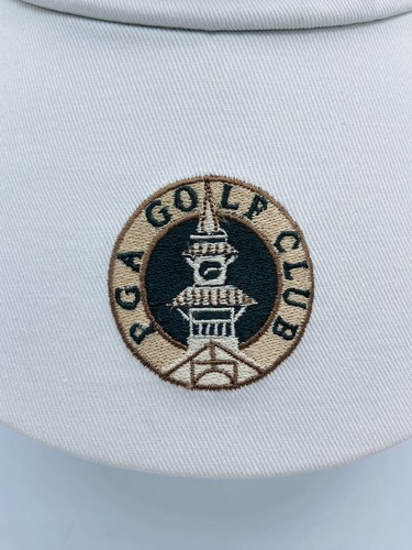 White golf visor with tan and brown embroidered tower and “VINTAGE” text, made in USA.