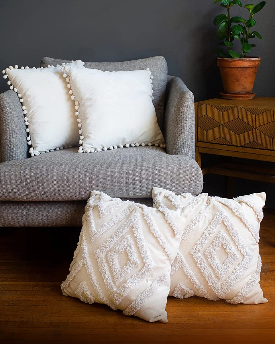 WHite and blue pillows accent a white linen couch placed in a