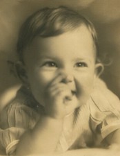 VERY HAPPY BABY PORTRAIT. 8 X 10 TONED SILVER PRINT IN FOLDER.
