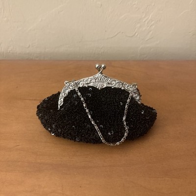Black sequined evening clutch purse with a silver frame 