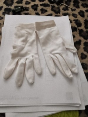 The image features a pair of white wrist-length formal gloves. These are...