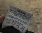 White fabric tag on black shirt with yellow “PRO LOGO” text, washing instructions, and bleach symbols.