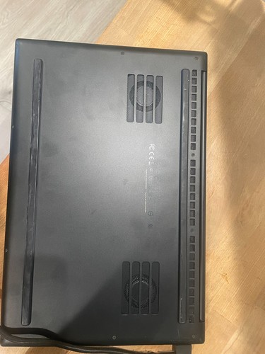 Black Razer Blade 15 15.6" with dual rear vents, silver fan blades, and printed specifications on the back panel.