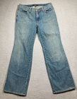 Blue stretch light wash Karen Kane women’s jeans with five-pocket design and visible white hardware on front thighs.