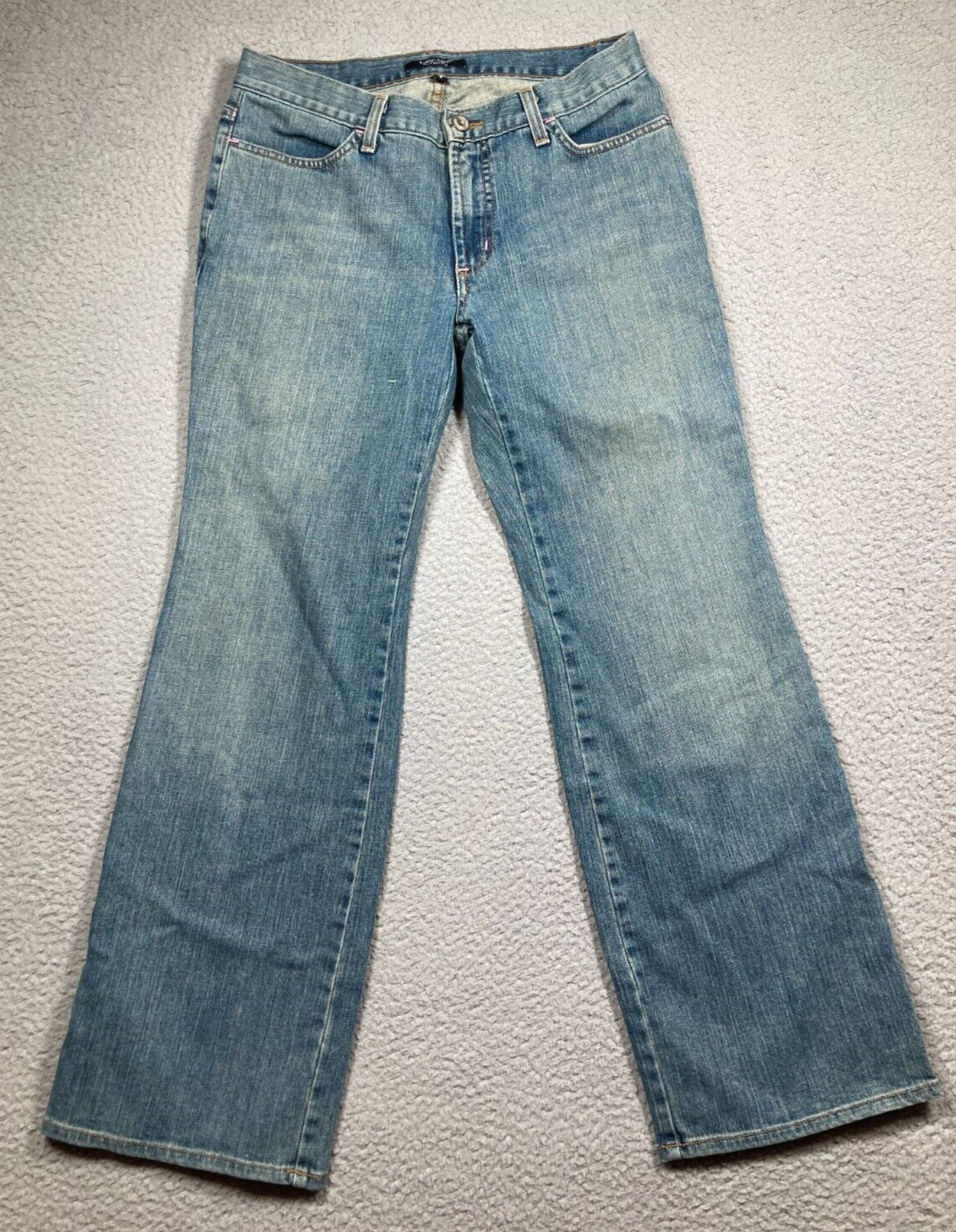 Blue stretch light wash Karen Kane women’s jeans with five-pocket design and visible white hardware on front thighs.
