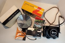 Vintage Petri 7 35mm camera kit with original box, accessories, and leather case