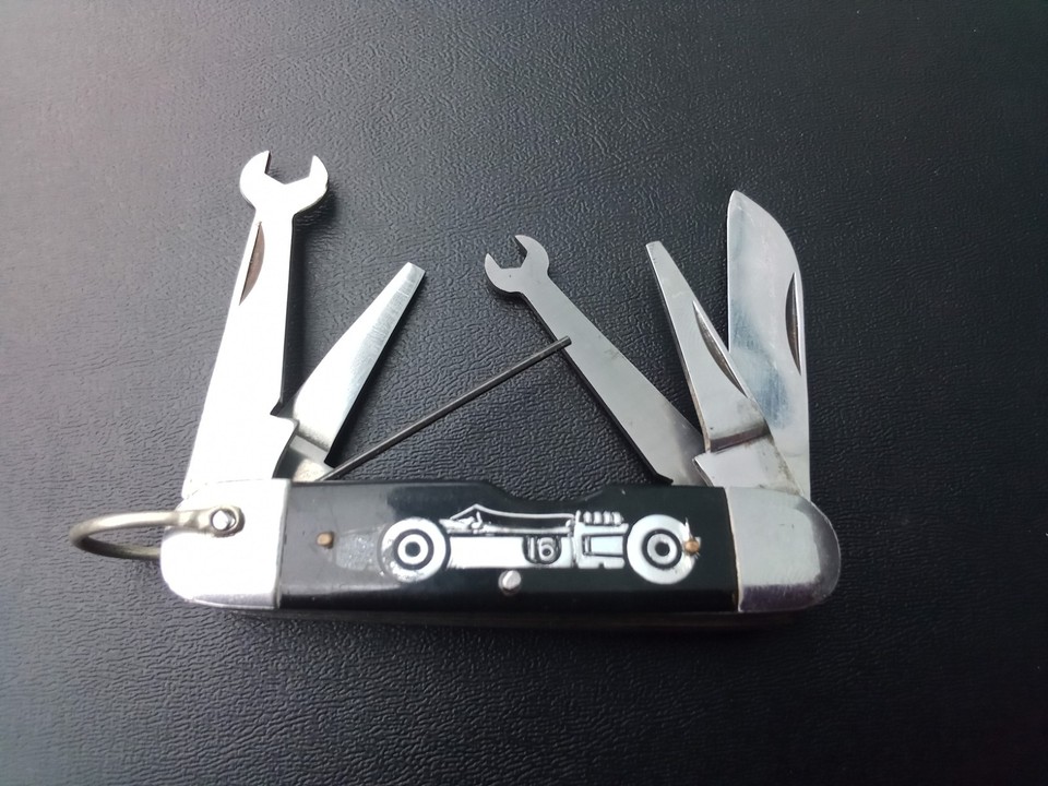 A 1960s Strombecker slot car racing–branded pocket knife multi-tool — a tiny piece of vintage motorsport toy history that doubles as a conversation-starting EDC.