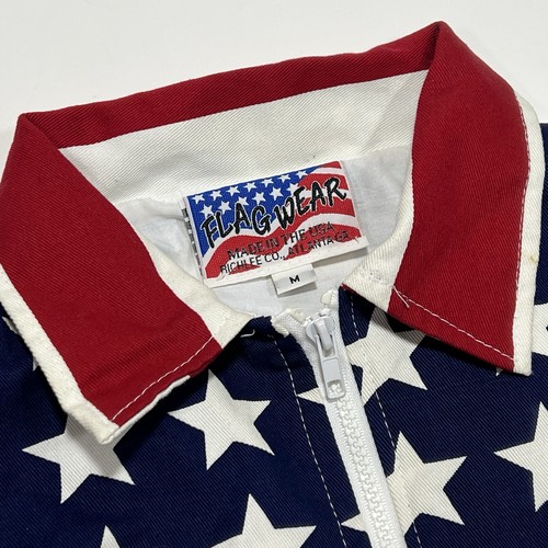 White vintage Flag Wear jacket with red and blue stars and “Made in U.S.A.” label on collar.