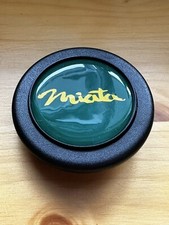 Miata Steering wheel horn push button.