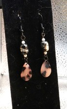 Animal print teardrop earrings dropping from black coated hooks