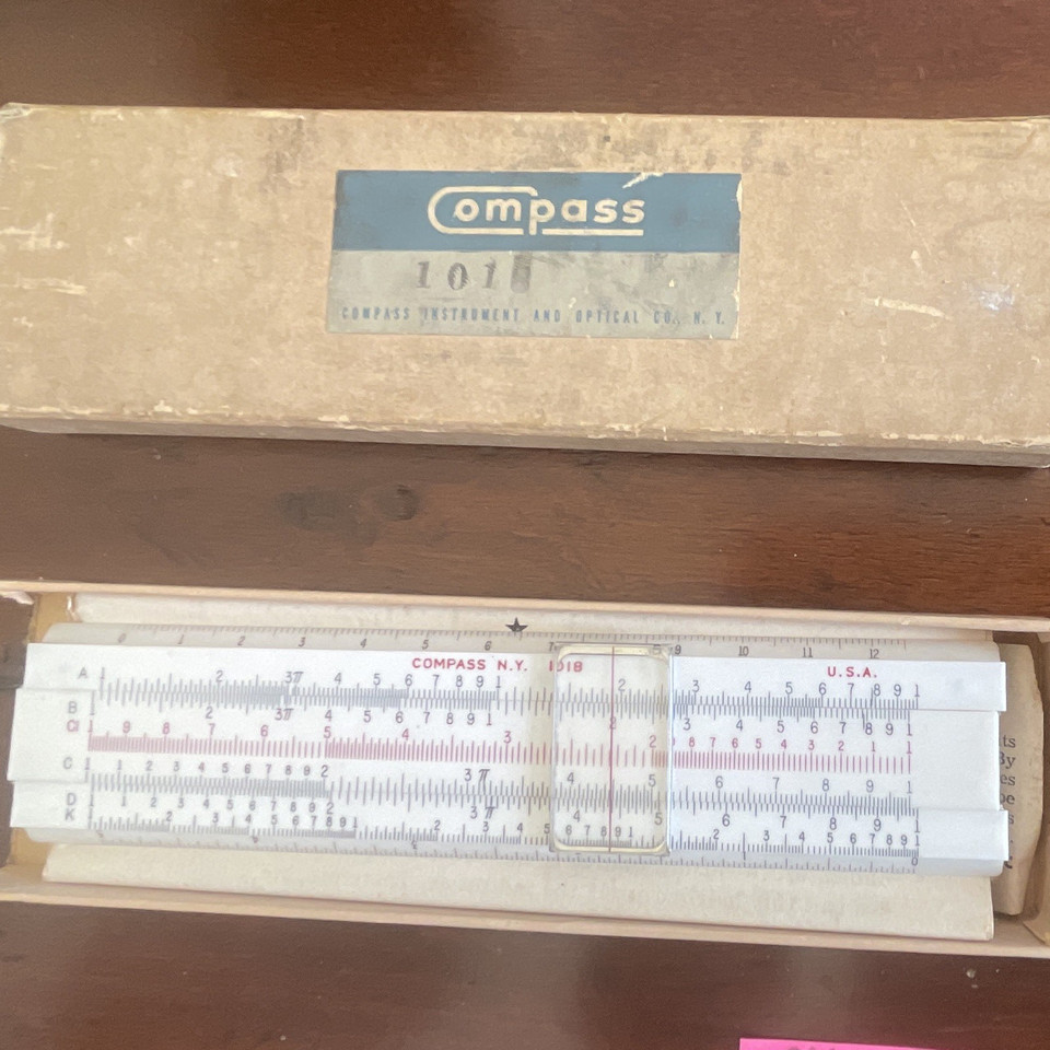 A fully mechanical analog computer in your pocket — this vintage compass slide rule with its original case and manual is a working relic of pre-digital engineering.