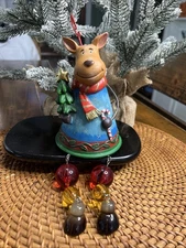 Christmas moose reindeer sitting with dangling legs christmas tree star