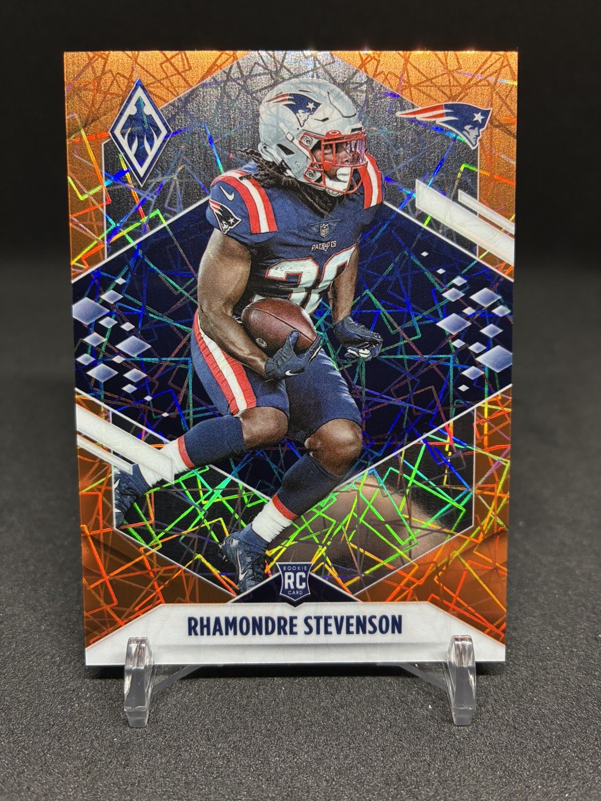 2021 Panini Phoenix #133 Rhamondre Stevenson Orange Lazer #/99 Rookie RC