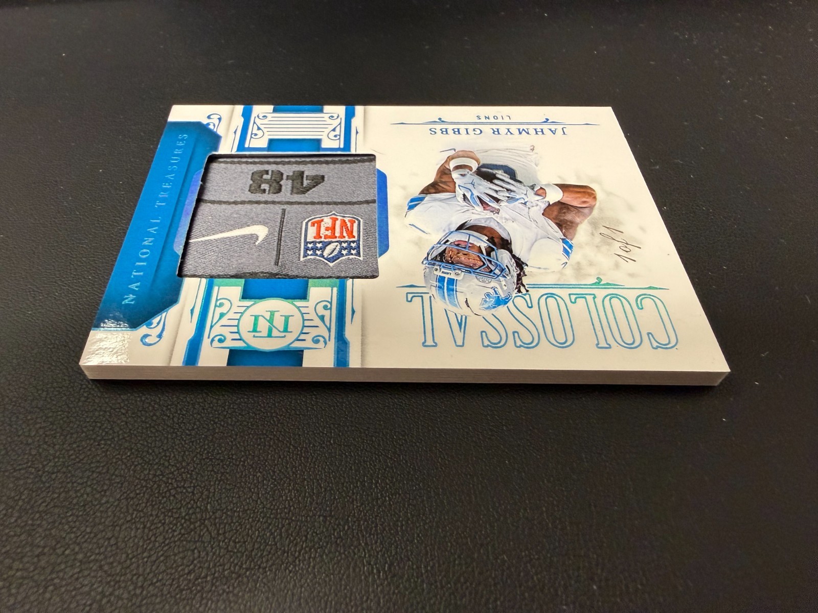 2025 National Treasures Jahmyr Gibbs 1/1 NFL Shield Nike Swoosh Colossal Patch view 2