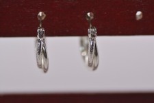 Small Silver Tone Textured and Smooth Twisted Hoop Earrings.  86 