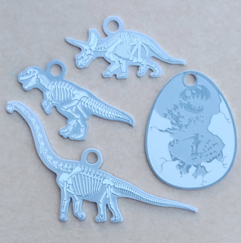 Dinosaur Skeleton Fossil Travel Tags/Geocoins Set of 4 - Activated & Adoptable