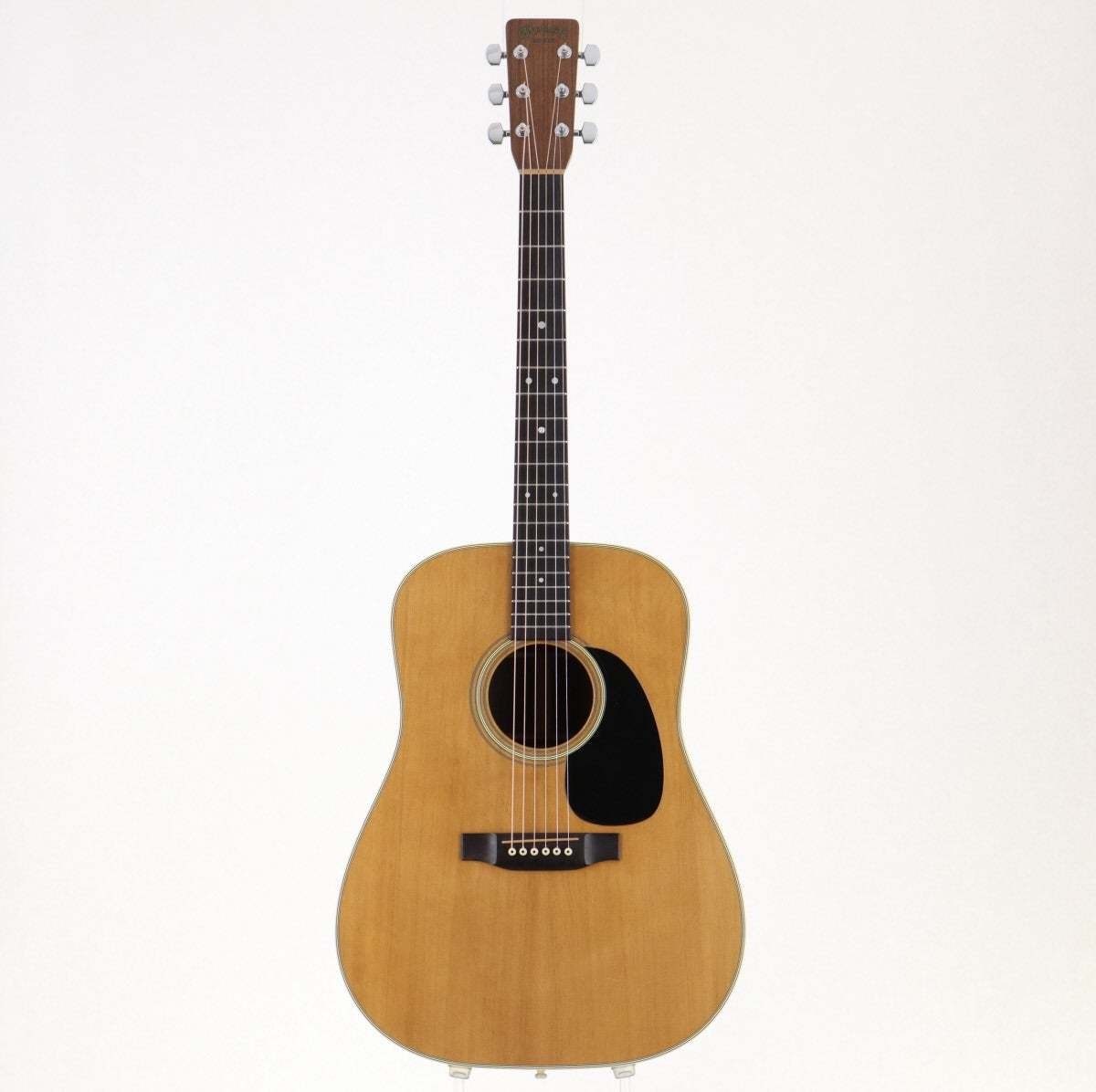 Light wood Martin D-28 acoustic guitar with black rosewood neck twist, six strings, and black case on white background.