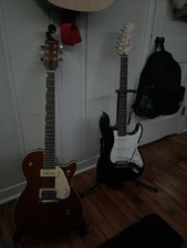 Brown Gretsch Electric Guitar And Black & White Stratocaster