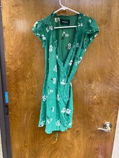 Women "Reformation”' green floral design short wrap dress. Size Sm. P.O.
