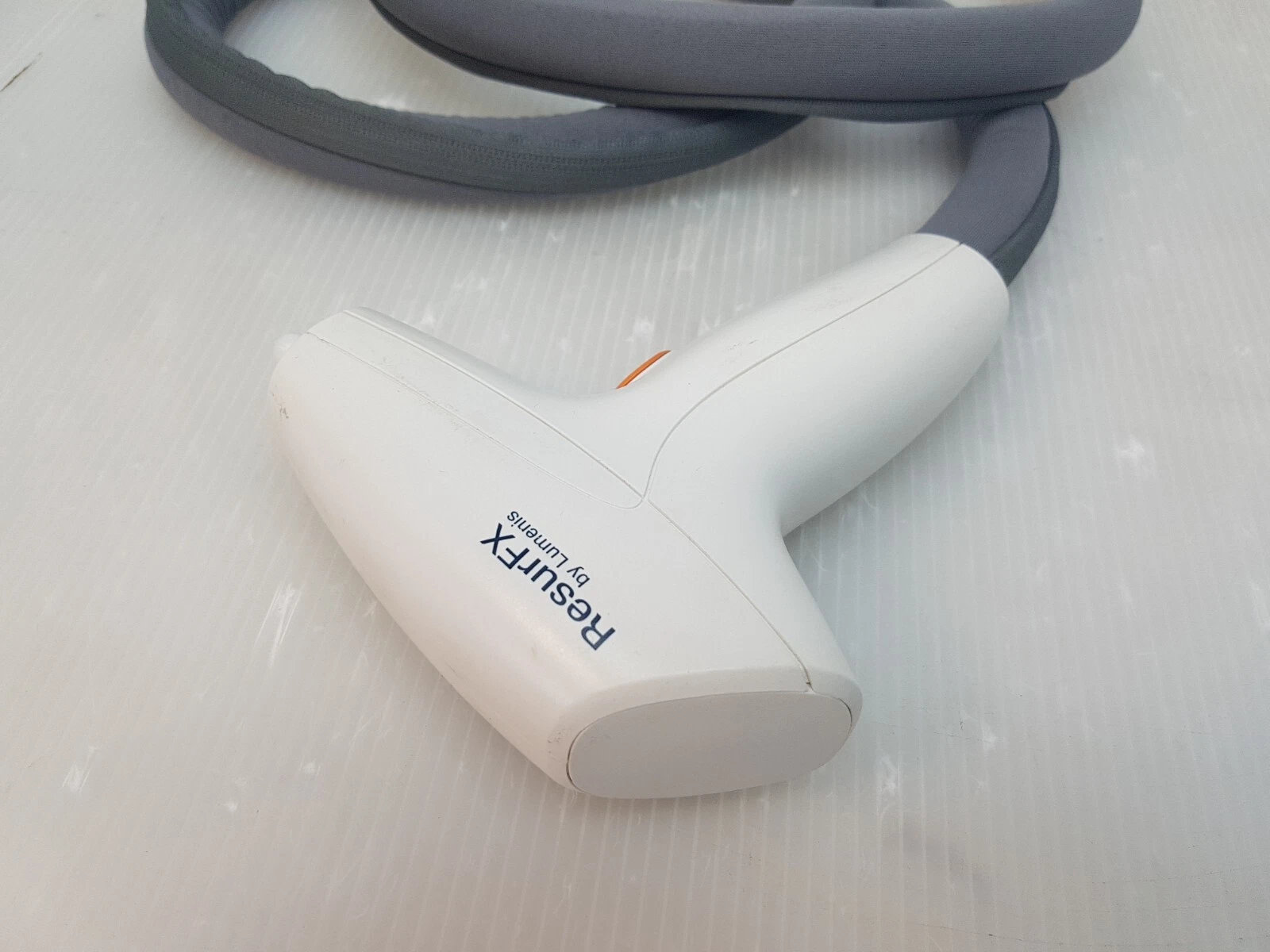 ResurFX handpiece front, logo side