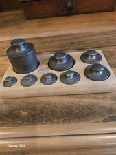 Apothecary weights, 2 sets, brass set of 8 in holder,  and porcelein set of 7