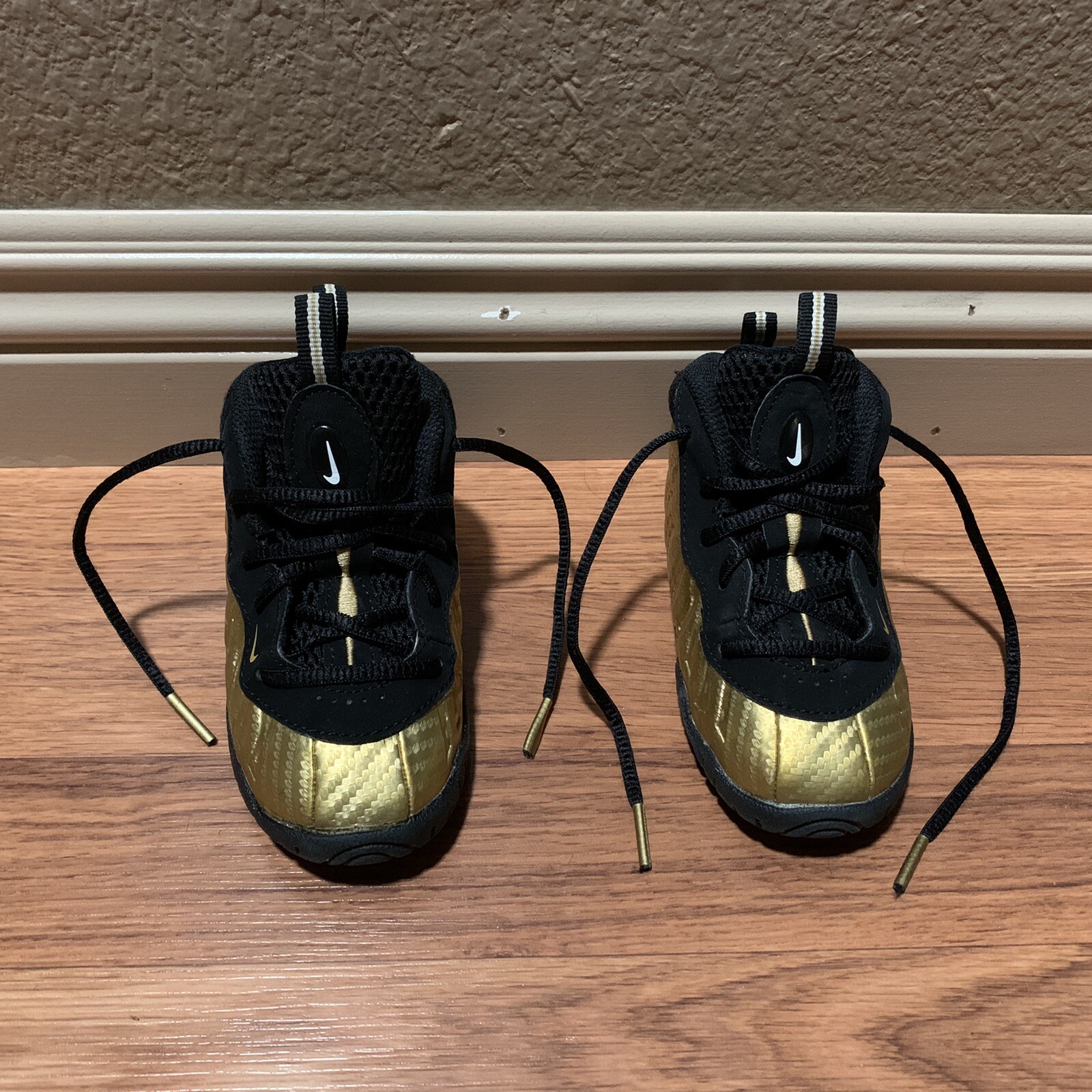black and gold foamposite toddler